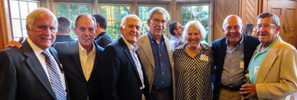 Classmates gather with Lynne Magnotto after a memorial service for her husband, John.