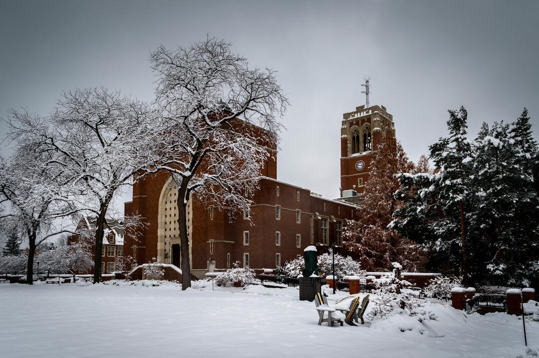 Beautiful photo of our administration building with the tower in full view, as the campus is covered in snow.