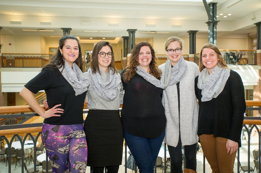 Participants in the Sisterhood of the Traveling scarf smile and get their picture taken.