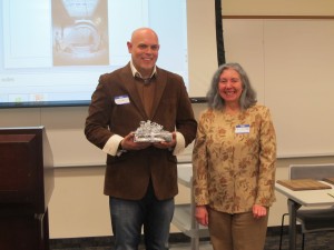 John Flock '99 received the physics department Distinguished Alumnus Award. To his right, Graciela Lacueva, the chair of the physics department.
